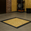 Basement floor hatch with OSB board mounted in concrete garage floor